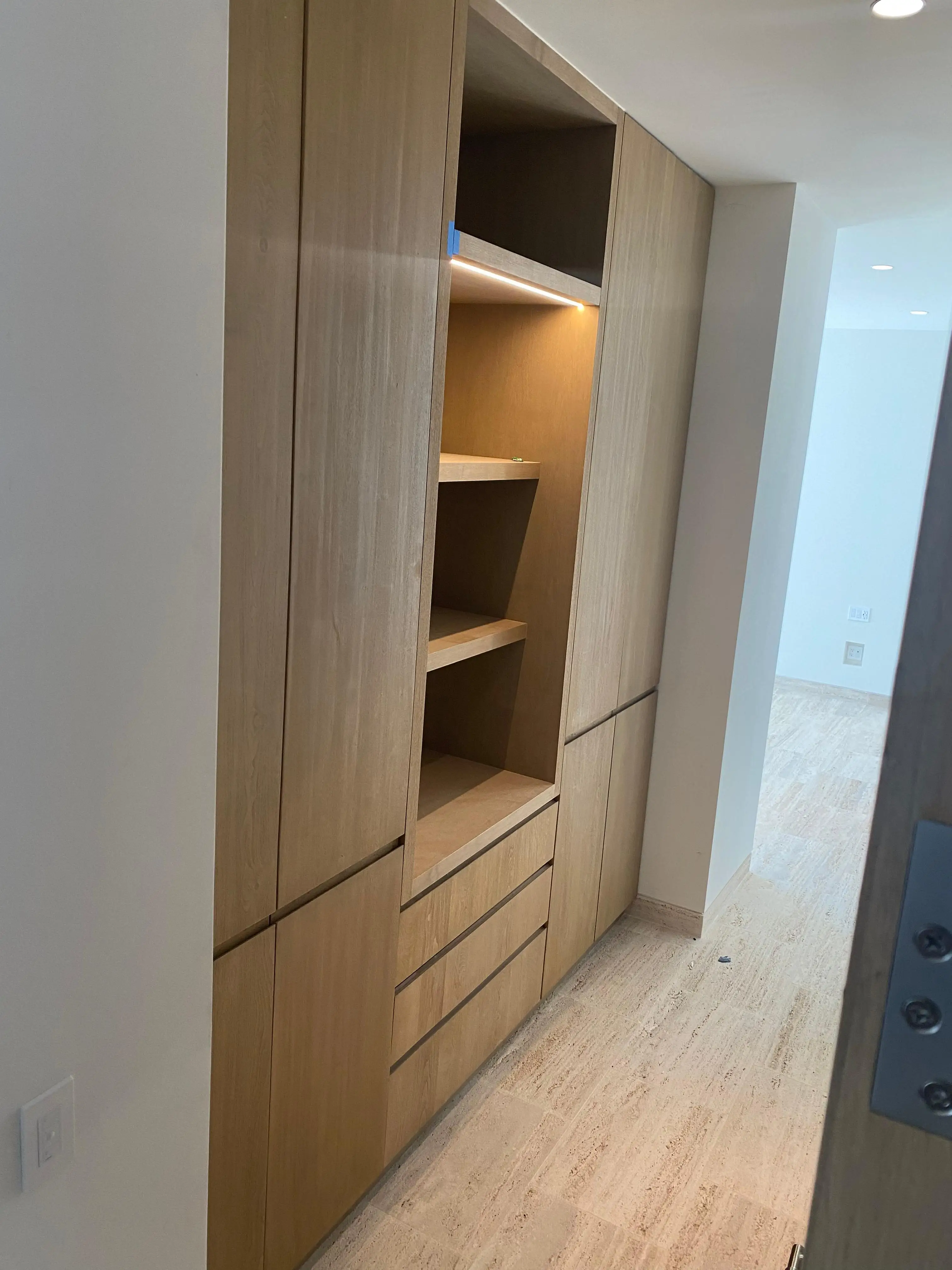 Master bedroom wood headboard wall with custom nightstands in Cabo San Lucas villa