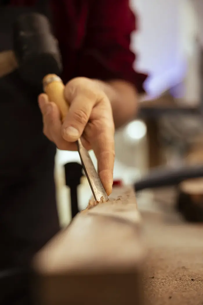 Hand shaping wooden pieces in San Jose del Cabo